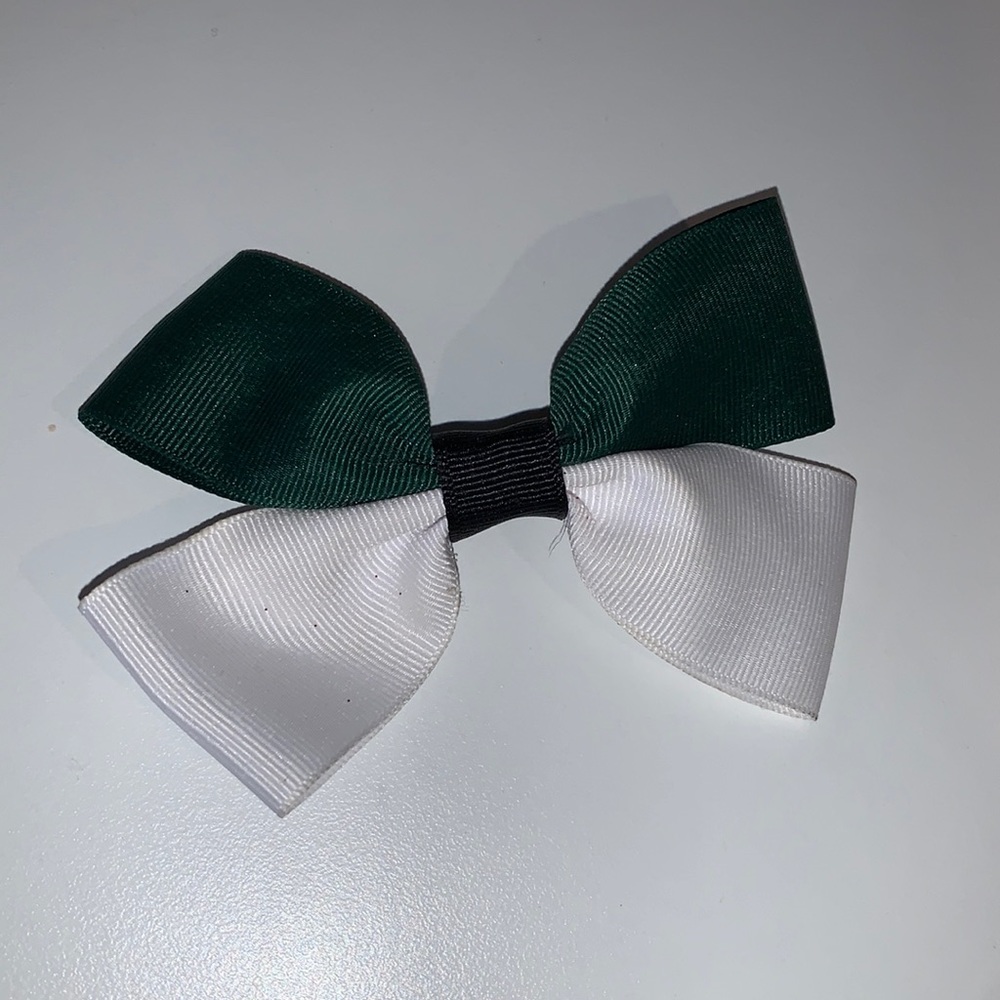 Green and white hair bow with black center